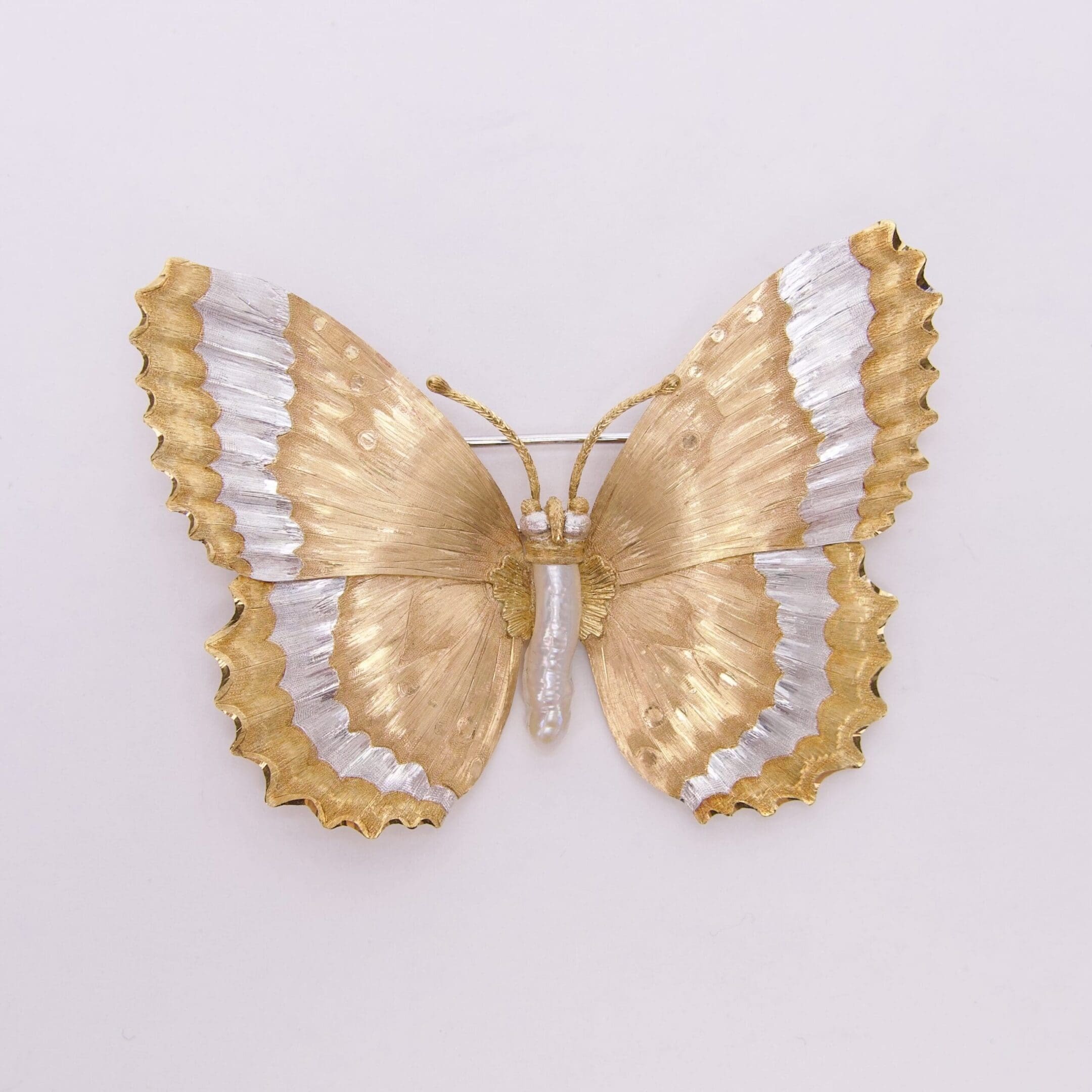 Golden and silver decorative butterfly on display.