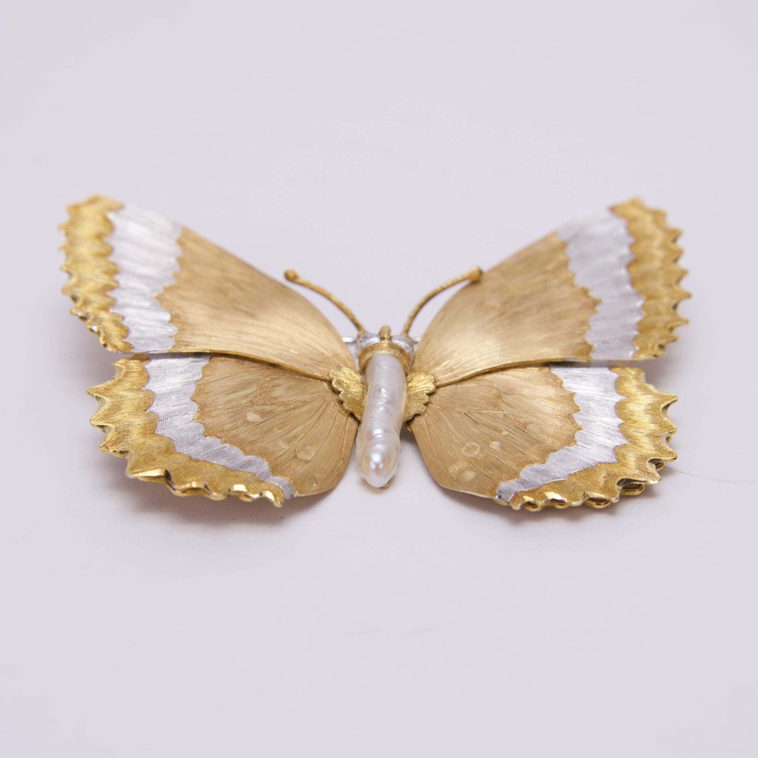 Gold and silver butterfly-shaped brooch.