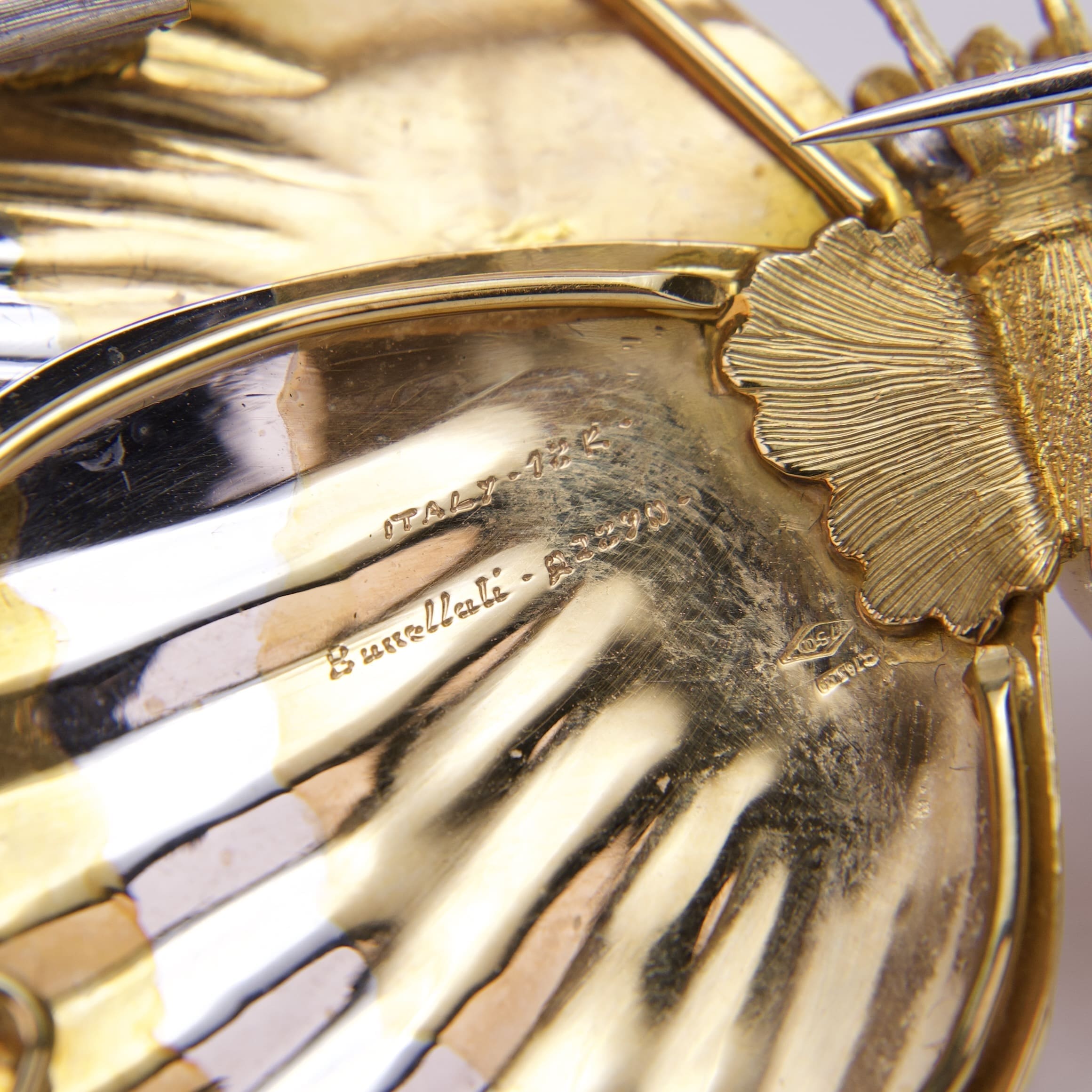 Golden butterfly sculpture with intricate engraved details.