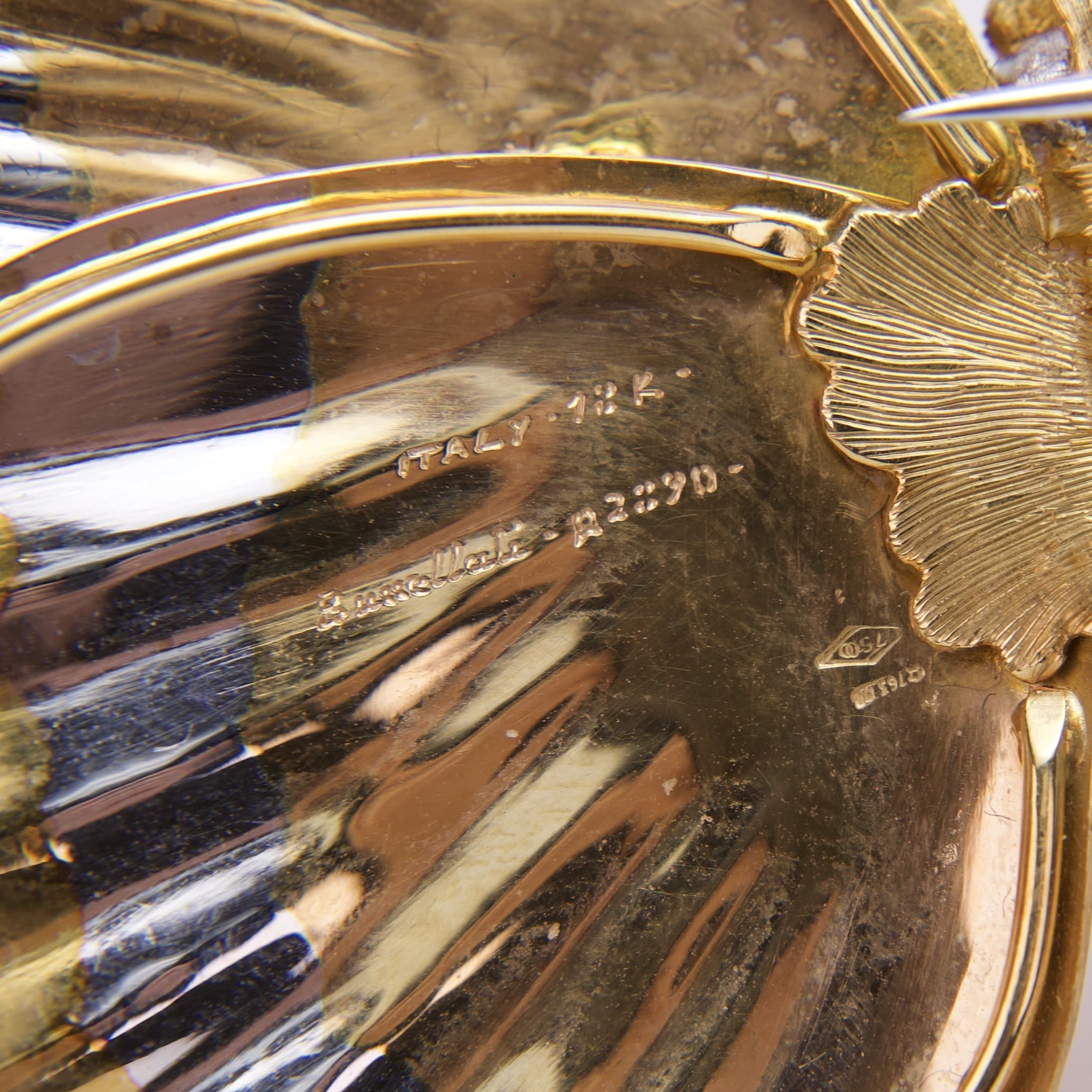 Gold and silver decorative etched metal surface.