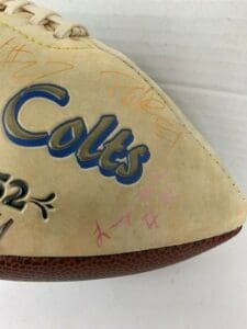 Autographed football with Colts logo visible.