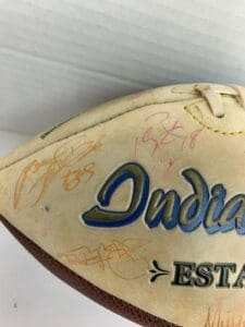 Signed football with multiple autographs visible.
