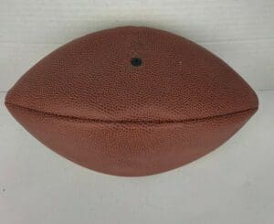 Deflated football on white background.