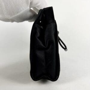 Side view of a black handbag.