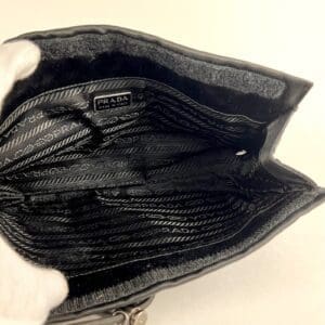 Open black Prada wallet with compartments.