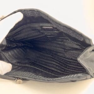 Open empty black designer handbag interior.