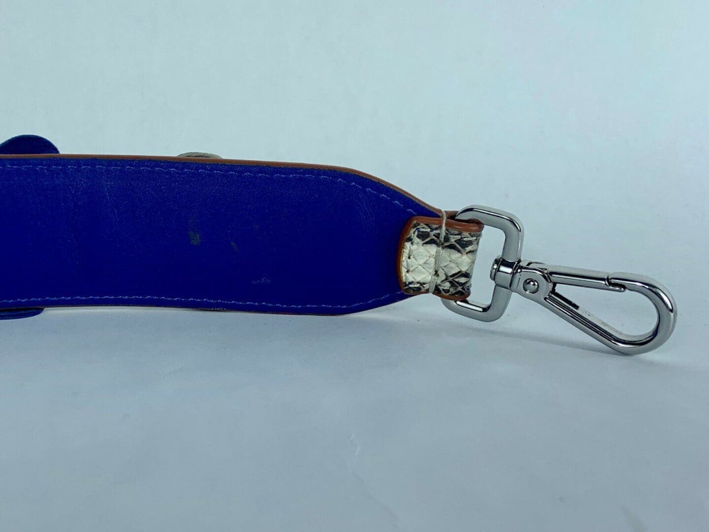 Blue strap with metal clasp attached.