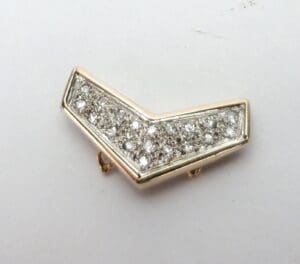 Gold and diamond chevron-shaped pin.