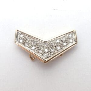 Gold chevron brooch with sparkling stones.