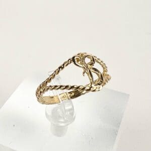 Gold twisted ring with decorative design.