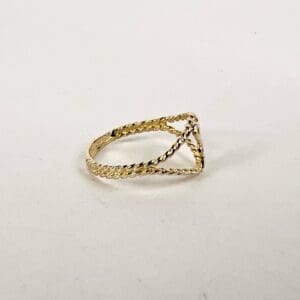 Gold braided ring on white background.