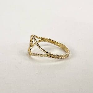 Gold twisted band ring on display.