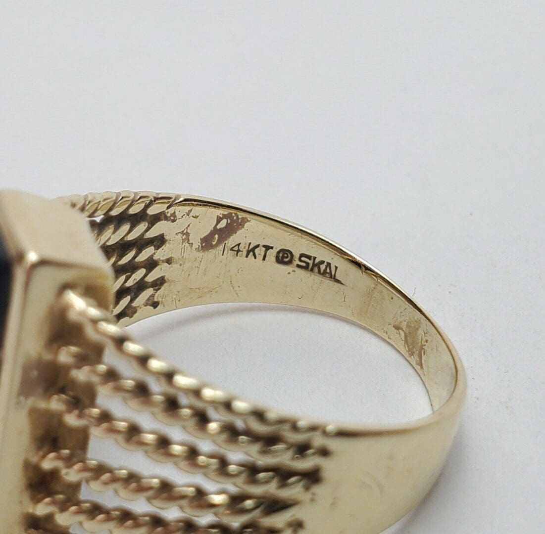 Gold ring with "14KT" engraving inside.